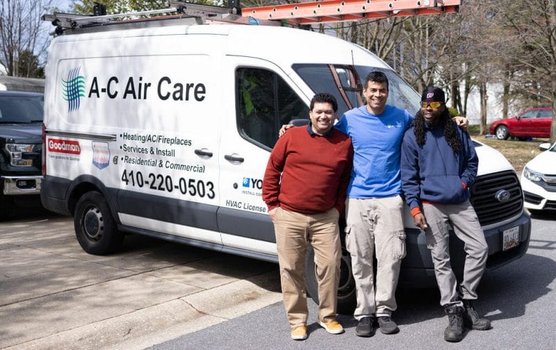 three technicians of ac air care in from of their van