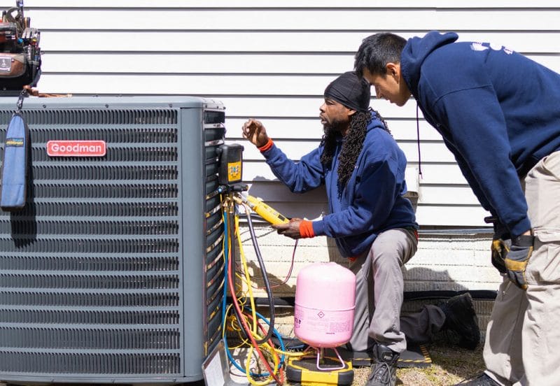 A-C Air Care technicians doing a maintenance on HVAC Goodman brand