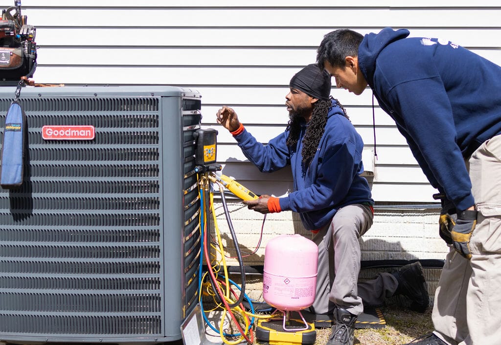 A-C Air Care technicians doing a maintenance on HVAC Goodman brand