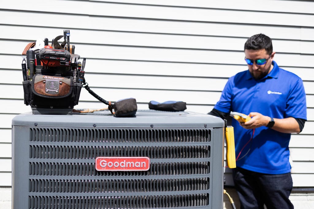 a a-c air care technician doing a heating maintenance