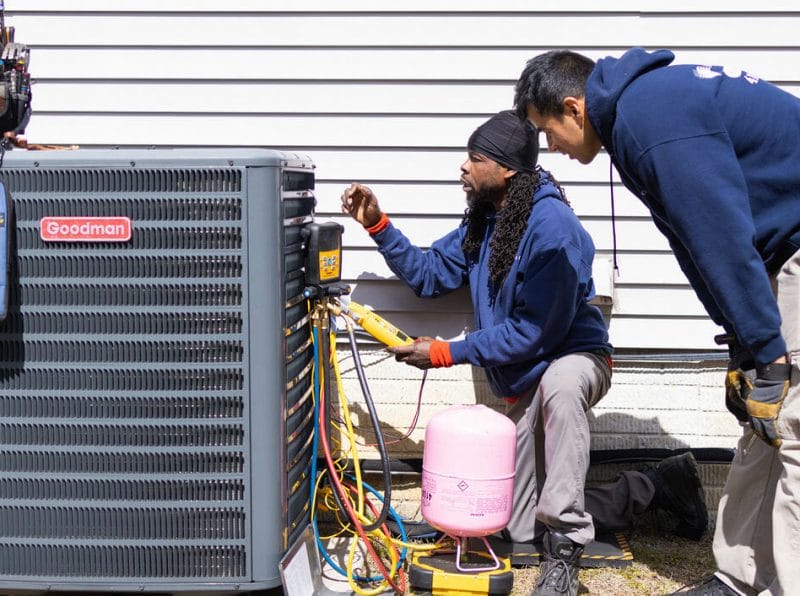 a a-c air care technician doing a heating service and repair in Elkridge, MD