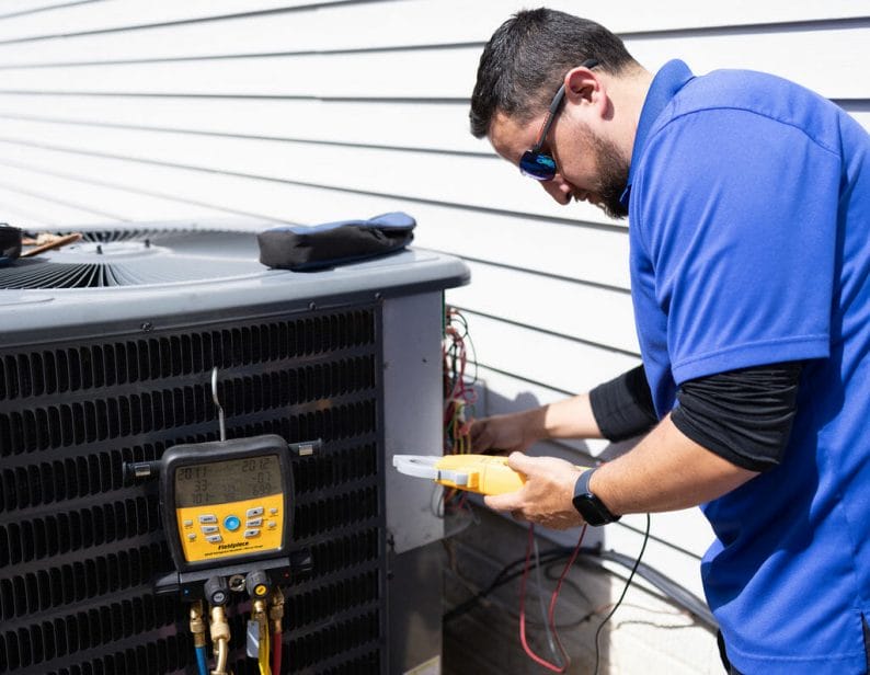 a a-c air care technician doing a heating service and repair in Elkridge, MD