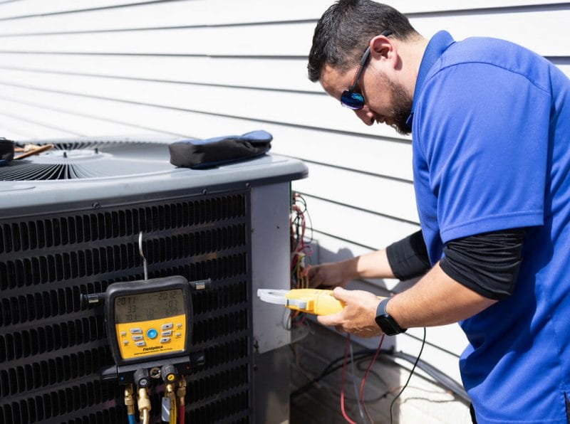 a a-c air care technician doing a heating service and repair in Elkridge, MD