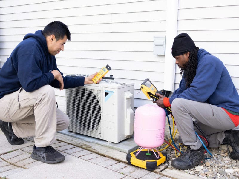 ac air care technicians installing a Daikin brand in Elkridge, MD