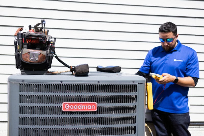 a a-c air care technician doing a heating maintenance